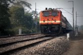 An Indian train pulled by an electric locomotive.