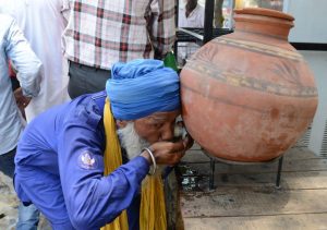 Sikh man drinks water on a hot day in Amritsar, Punjab