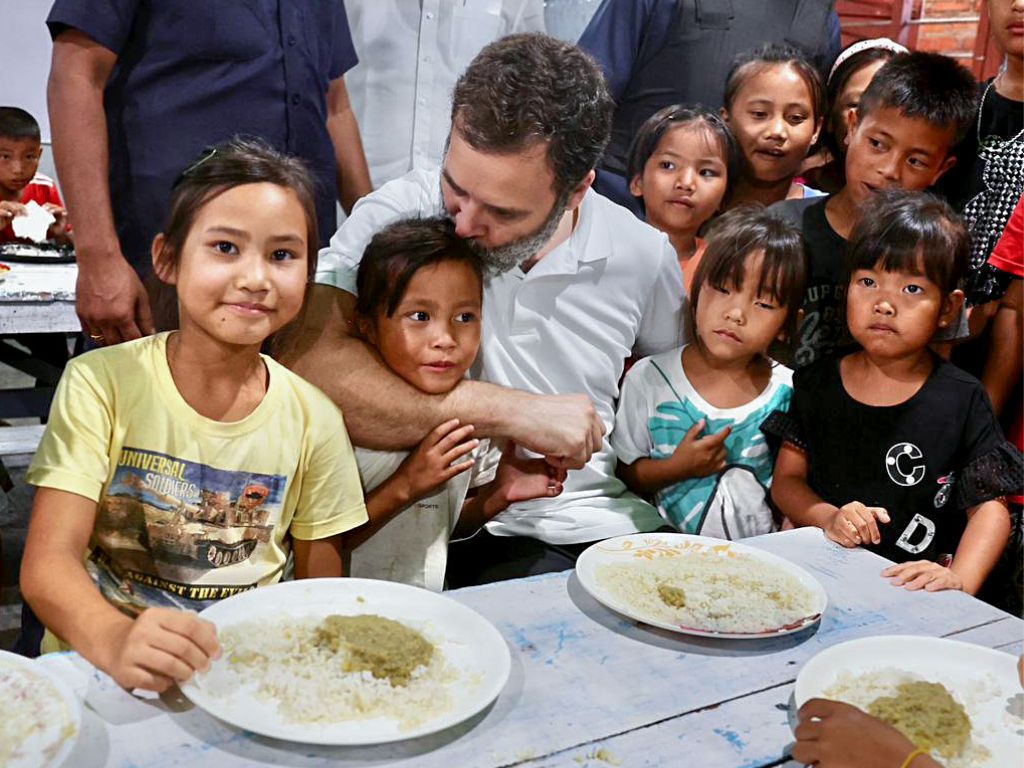 Indian National Congress leader Rahul Gandhi has lunch with children at a relief camp during his visit to the violence-hit Manipur