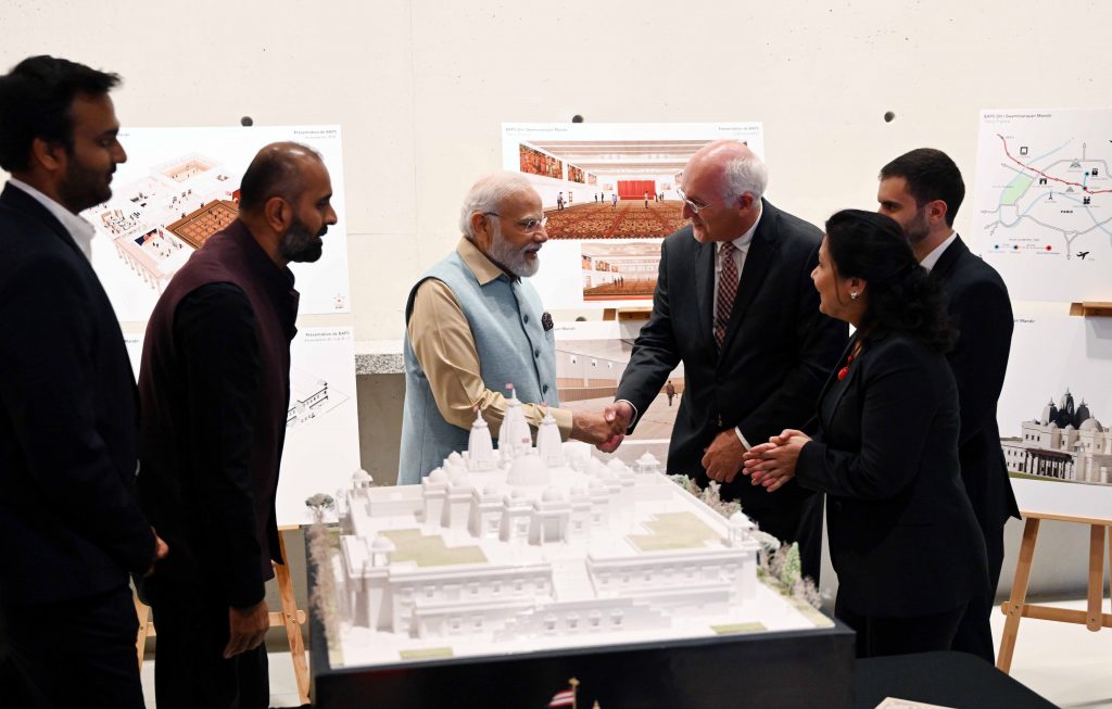 Indian prime minister Narendra Modi with BAPS volunteers and members of the architect of the upcoming temple in Paris, Arte Charpentier, during his recent visit to France in July 2023.