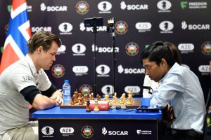 India's Rameshbabu Praggnanandhaa (R) competes against Norway's Magnus Carlsen (L) during the final at the FIDE Chess World Cup