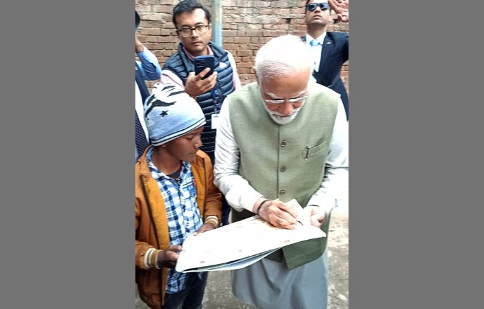 PM Modi gives autograph to a boy