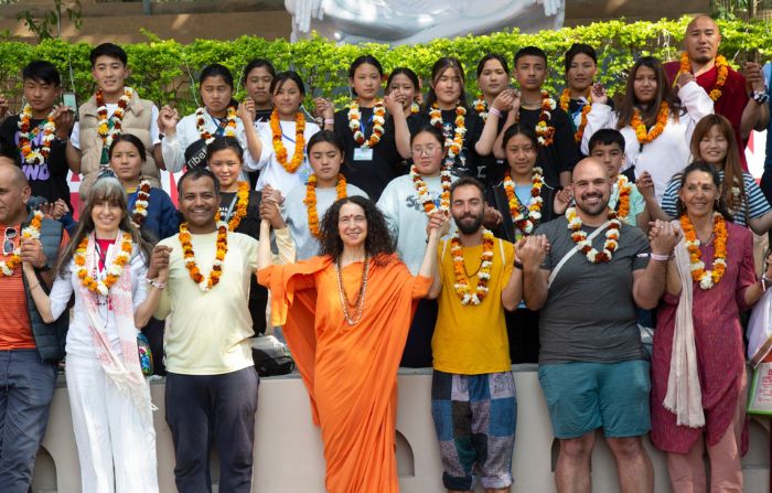 Pujya Sadhvi Bhagawati Saraswati Ji (in saffron), director International Yoga Festival, with participants of the International Yoga Festival at Parmarth Niketan Ashram in Rishikesh