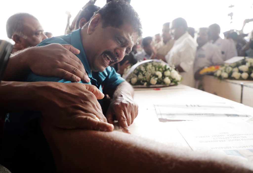 A man breaks down over the coffin carrying the mortal remains of one of the 46 Indians who were killed in a fire in Kuwait on June 12. 