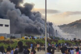 People gather near a chemical godown of the electronics component factory of Tata Electronics Pvt Ltd